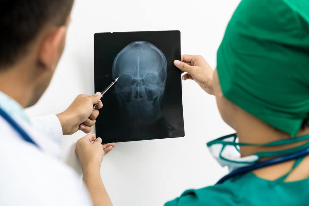 A Doctor and nurse watching someone's Xray's